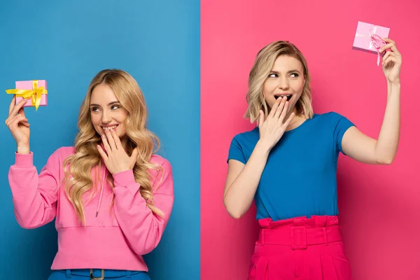 Shocked blonde sisters holding presents on blue and pink background — Stock Photo