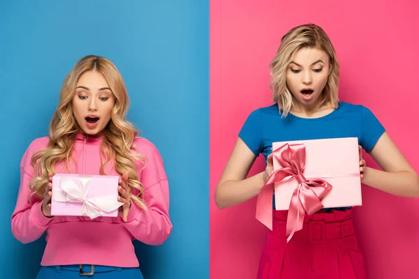 Schockierte blonde Mädchen mit Geschenkschachteln auf blauem und rosa Hintergrund — Stockfoto