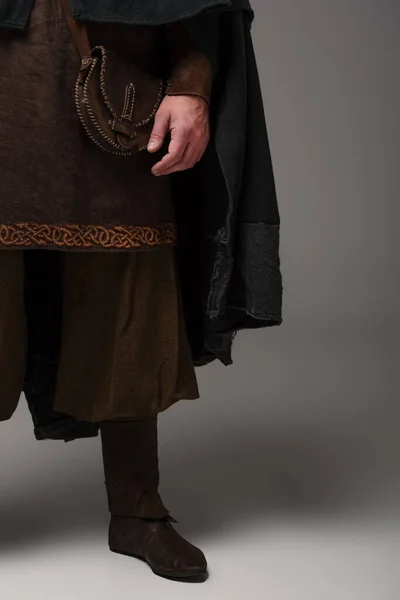 Cropped view of medieval Scottish man in mantel on grey background — Stock Photo