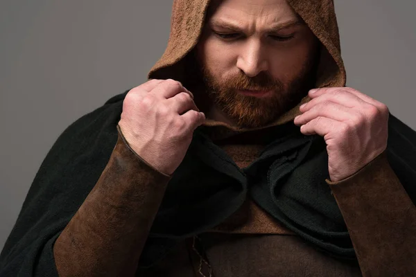 Portrait of serious medieval Scottish redhead man in mantel on grey background — Stock Photo