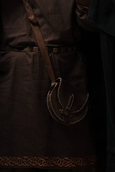 Close up view of medieval brown clothing and leather bag — Stock Photo