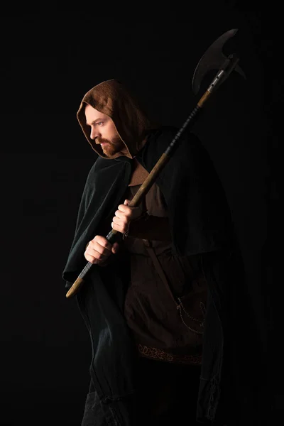 Medieval Scottish warrior with battle axe in mantel isolated on black — Stock Photo