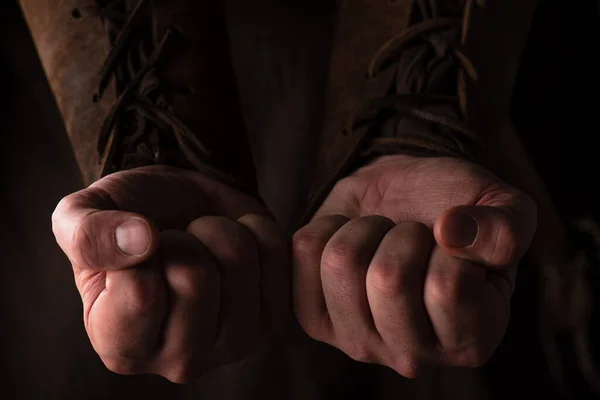 Fists of medieval Scottish man in brown clothing — Stock Photo