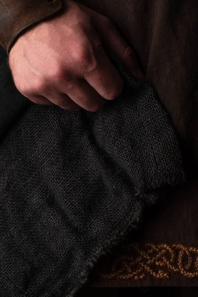Mano del hombre adulto escocés medieval en ropa marrón - foto de stock