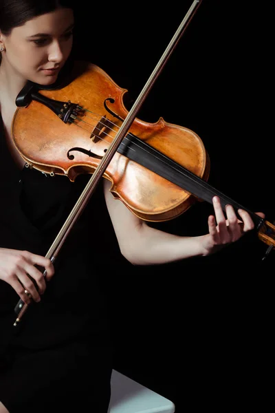 Attractive female musician playing on violin on dark stage — Stock Photo