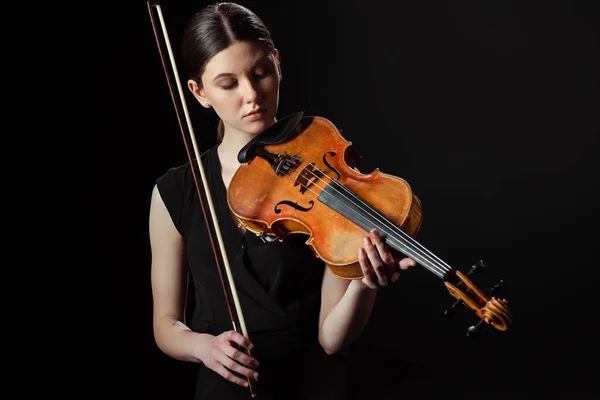 Beautiful musician playing symphony on violin isolated on black — Stock Photo