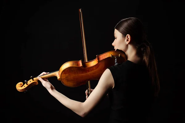 Beautiful professional musician playing on violin isolated on black — Stock Photo