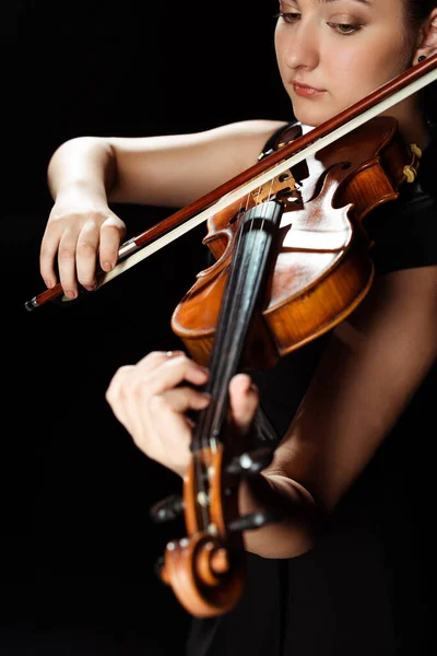Attractive professional musician playing symphony on violin isolated on black — Stock Photo