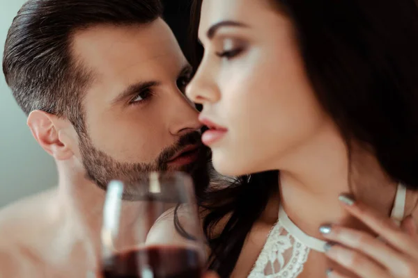 Selective focus of man looking at sexy woman with red wine and closed eyes — Stock Photo