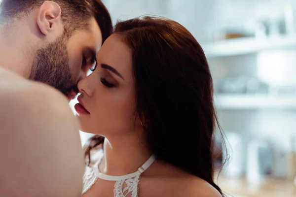Sexy young undressed couple kissing with closed eyes — Stock Photo