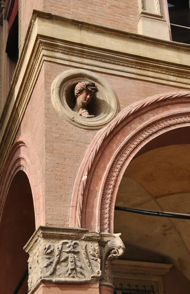art object on a facade of a building and portico in public highway of Bologna near San Stephan