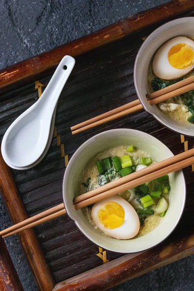 Asian soup with eggs, onion and spinach — Stock Photo, Image