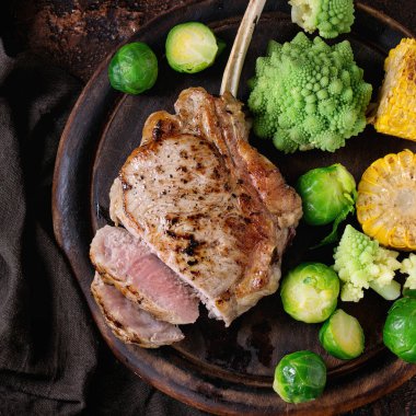 Grilled veal steak with vegetables clipart