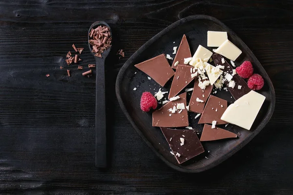 Variety of chopping chocolate with raspberries