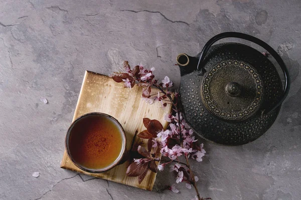 Théière et tasse de thé avec branche de fleur — Photo