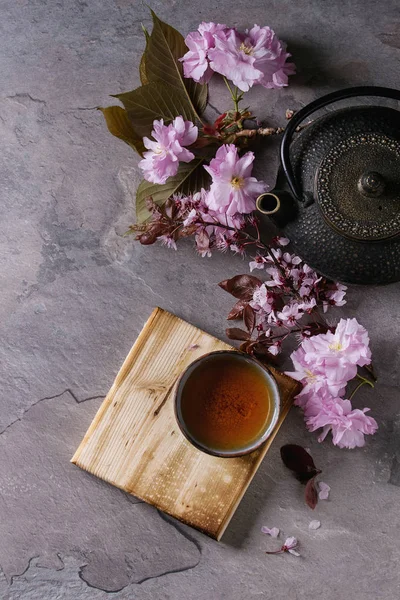 Teapot and cup of tea with blossom branch — Stock Photo, Image