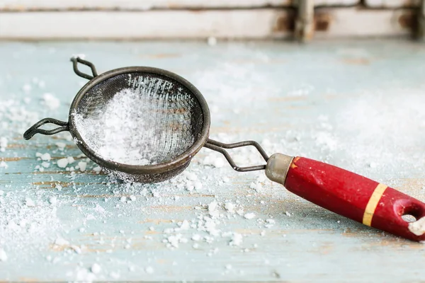 Sugar powder in vintage sieve — Stock Photo, Image