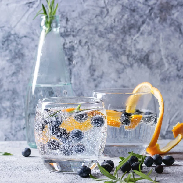 Tonic cocktail with rosemary and blueberries