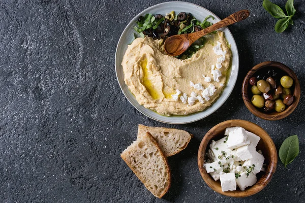 Hummus with olives and herbs — Stock Photo, Image