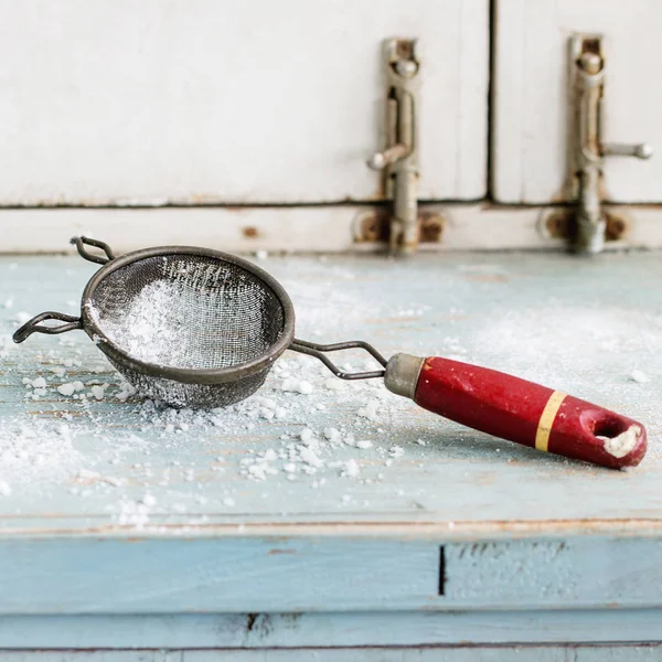 Sugar powder in vintage sieve — Stock Photo, Image