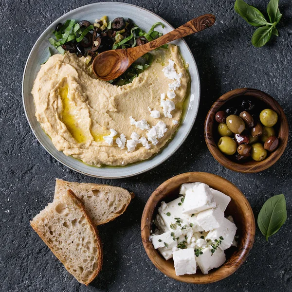 Hummus with olives and herbs — Stock Photo, Image
