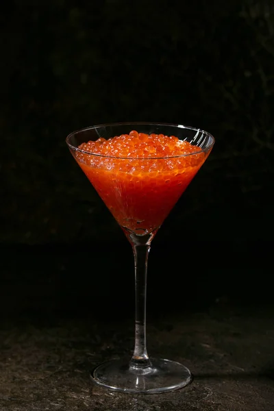 Glass of red caviar