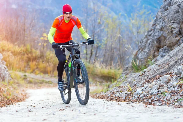 Hombre bicicleta de montaña cuesta arriba paseo en el camino de hormigón — Foto de Stock