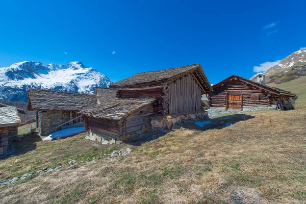 Typical Swiss wooden cabins in high mountain pastures — Stock Photo, Image