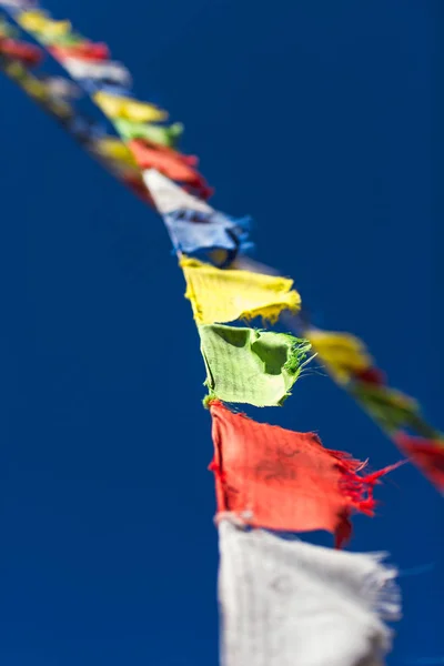 Closeup of colorful Tibetan Buddhist prayer flags waving in the — Stock Photo, Image