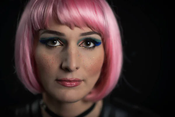 Portrait of girl on a black background with pink wig and colored — Stock Photo, Image