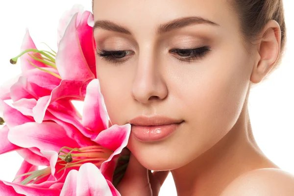 Portrait of young beautiful caucasian woman with pink lilies — Stock Photo, Image