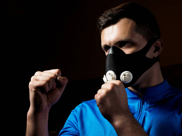 Man boxing in training mask