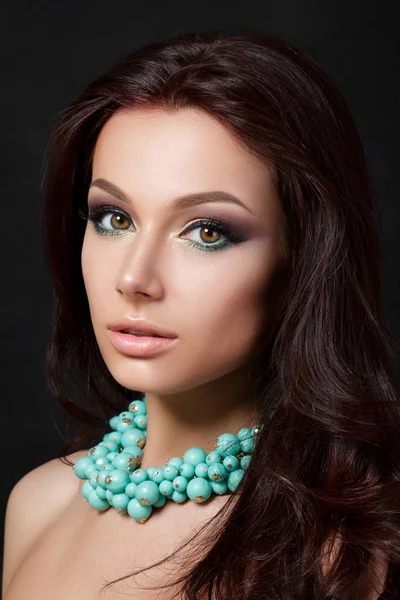 Portrait of young beautiful woman wearing blue necklace — Stock Photo, Image