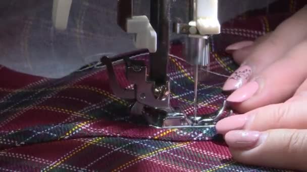 Close-up shooting of womens hands working on a sewing machine . — Stok video