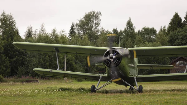 Agricultural airplane stands in a field in the green grass. — ストック写真