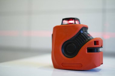 Laser level, used in apartment renovation. Optical instrument for accurate horizon level.