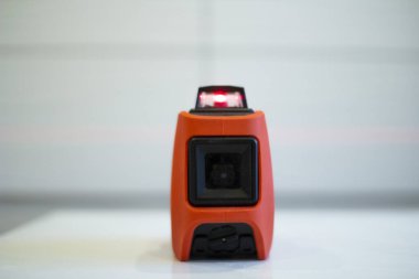 Laser level, used in apartment renovation. Optical instrument for accurate horizon level.