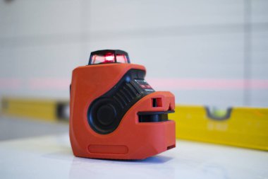 Laser level, used in apartment renovation. Optical instrument for accurate horizon level.