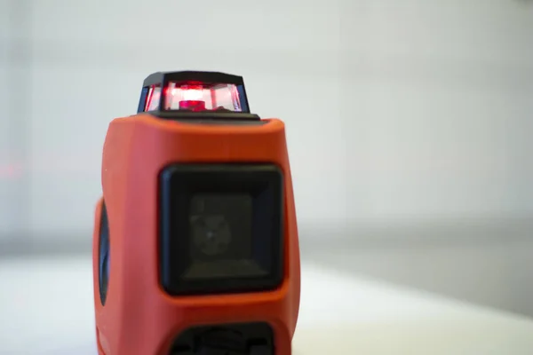 Laser level, used in apartment renovation. Optical instrument for accurate horizon level.