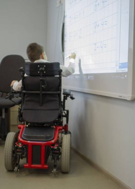 İlkokulda tekerlekli sandalyede sakat bir öğrenci..