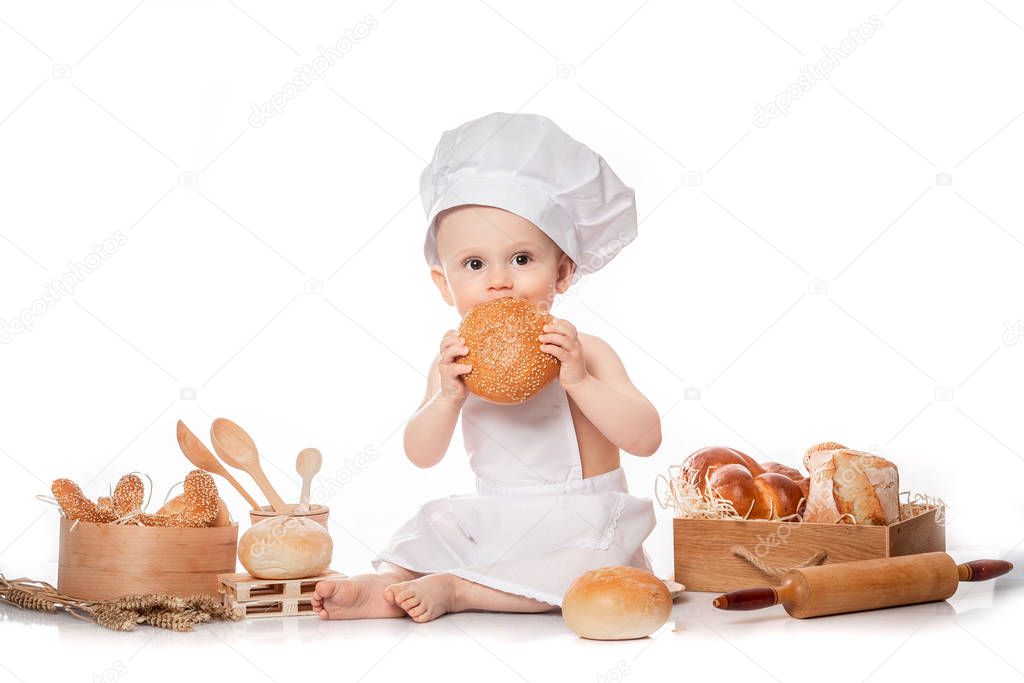 Little baby chef with bread. isolated on white. big size resolution. Food banner for text or design. Cooking child lifestyle concept