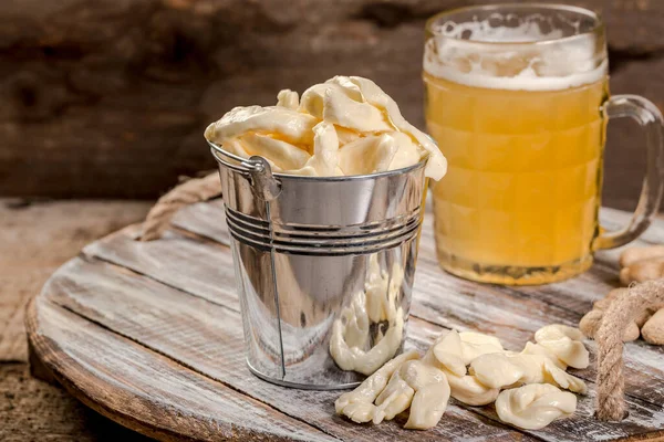 cheese appetizer and beer on vintage background.