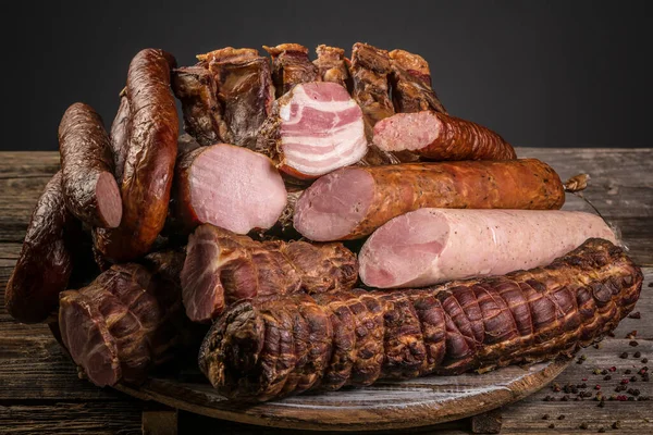 Assorted meat products including ham and sausages. ariety of processed cold meat products.