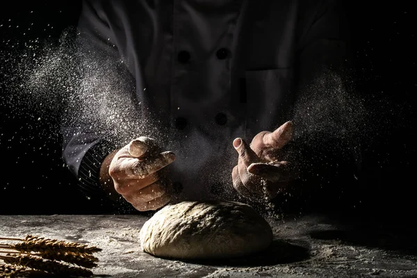 Photo of flour and men hands with flour splash. Cooking bread. Kneading the Dough. Isolated on dark background. Empty space for text.