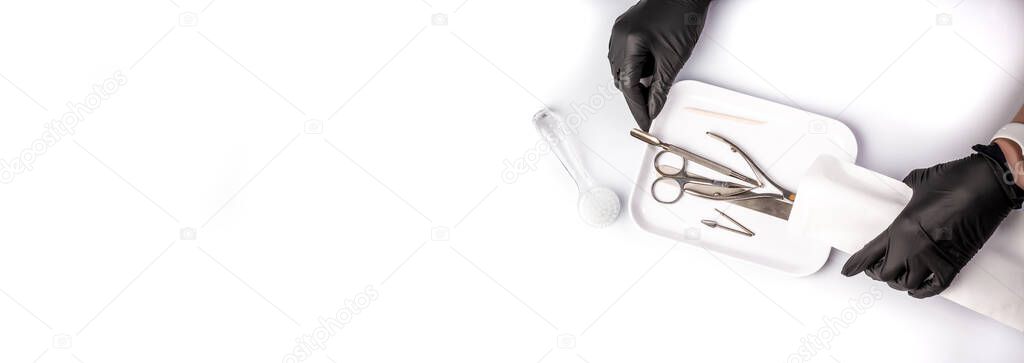 Hands taking manicure tools from craft envelope before manicure procedure. rofessional tools for manicure. The concept of beauty. Medical tool. banner place for text.