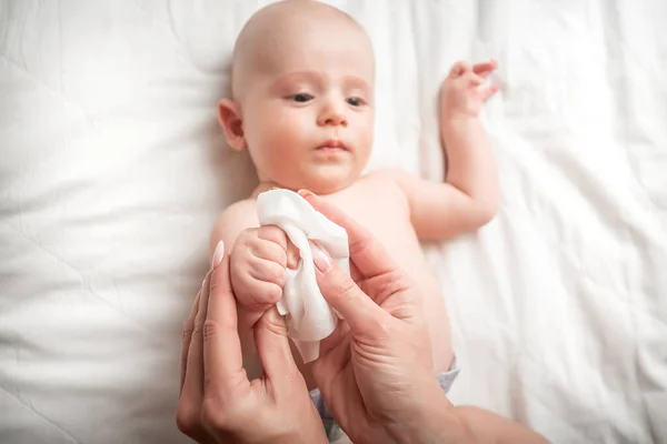 コンセプト衛生洗浄 清潔で清潔なワイプ 若いお母さんおむつテーブルの上にタオルに包まれたシャワー赤ちゃんの後 — ストック写真