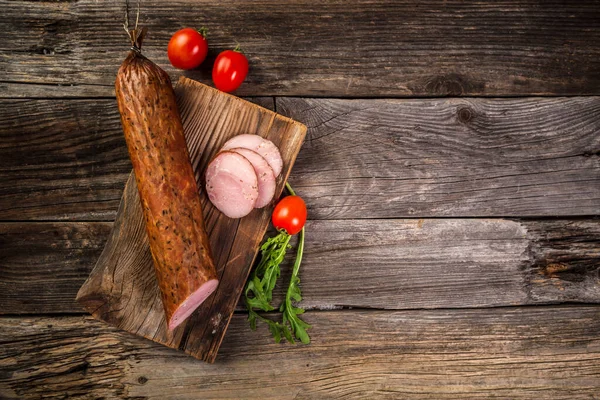 Smoked sausage on a wooden rustic table. banner menu recipe place for text.
