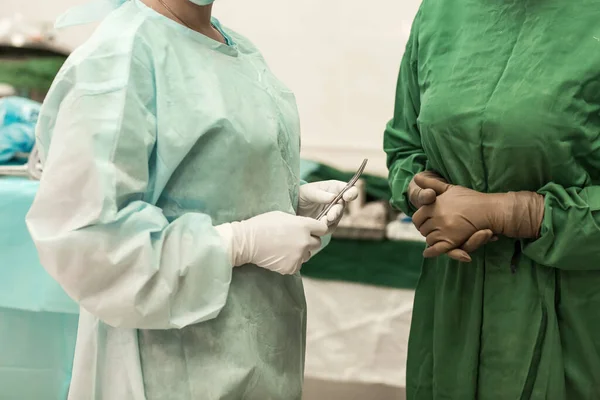 Healthcare workers in the Coronavirus Covid19 pandemic. Concentrated surgeons operating a patient in an operating.