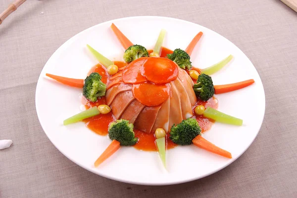 Delicate sliced broccoli and carrot in a white ceramic dish