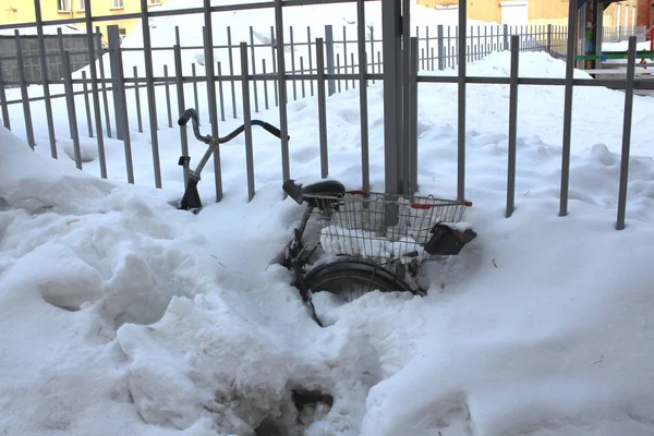 Bicicleta esquecida completamente enterrada em um snowdrift no inverno perto de t — Fotografia de Stock